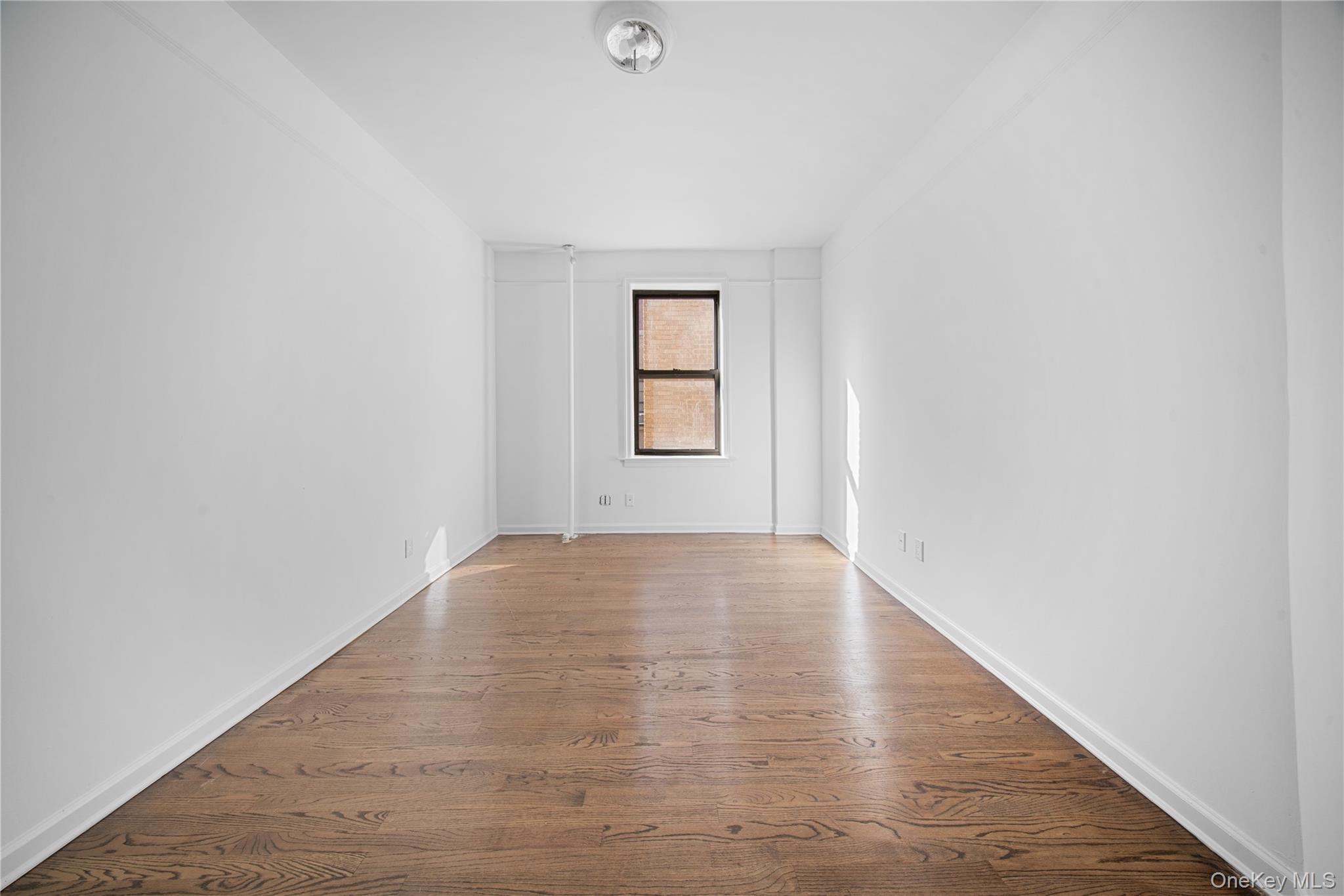 779 Riverside Drive, Unit C63/C64 Manhattan, NY 10032 - Photo 12 of 16 an empty room with windows and closet