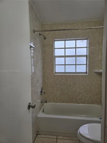 a bathroom with a toilet and a bathtub