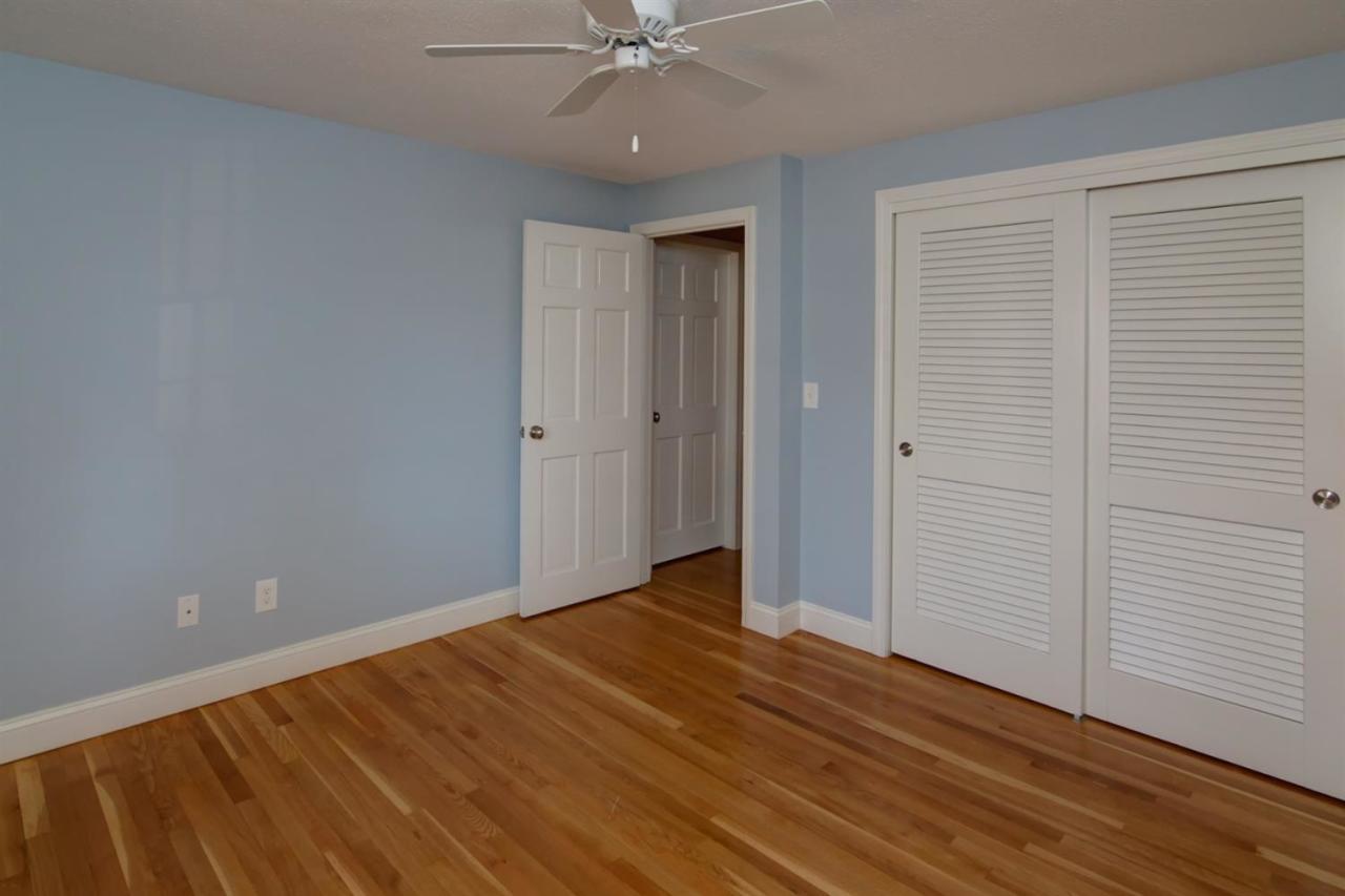 140 Ansel Howland Road Centerville, MA 02632 - Photo 16 of 26 a view of an empty room with wooden floor