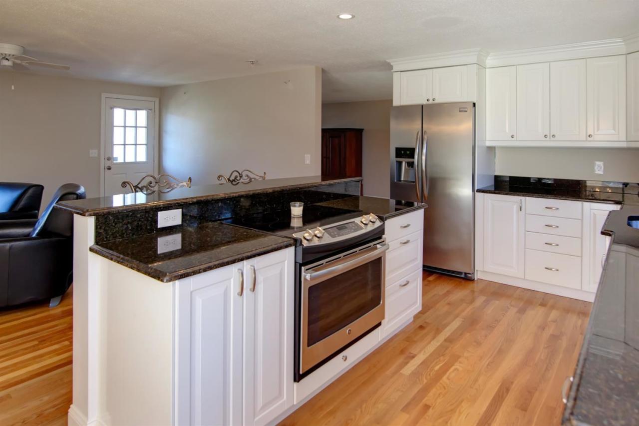 140 Ansel Howland Road Centerville, MA 02632 - Photo 3 of 26 a kitchen with granite countertop a stove and a refrigerator