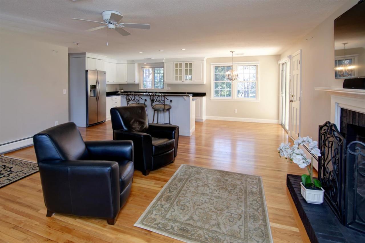 140 Ansel Howland Road Centerville, MA 02632 - Photo 6 of 26 a living room with furniture and a fireplace