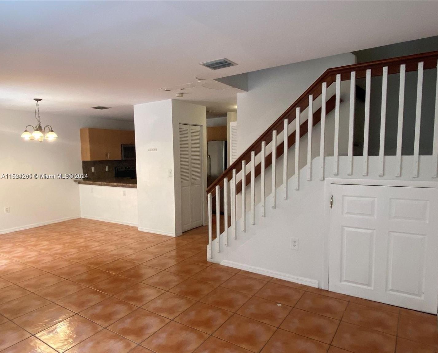 Kendale Lakes Miami, FL 33183 - Photo 5 of 8 a view of a hallway with wooden floor and staircase