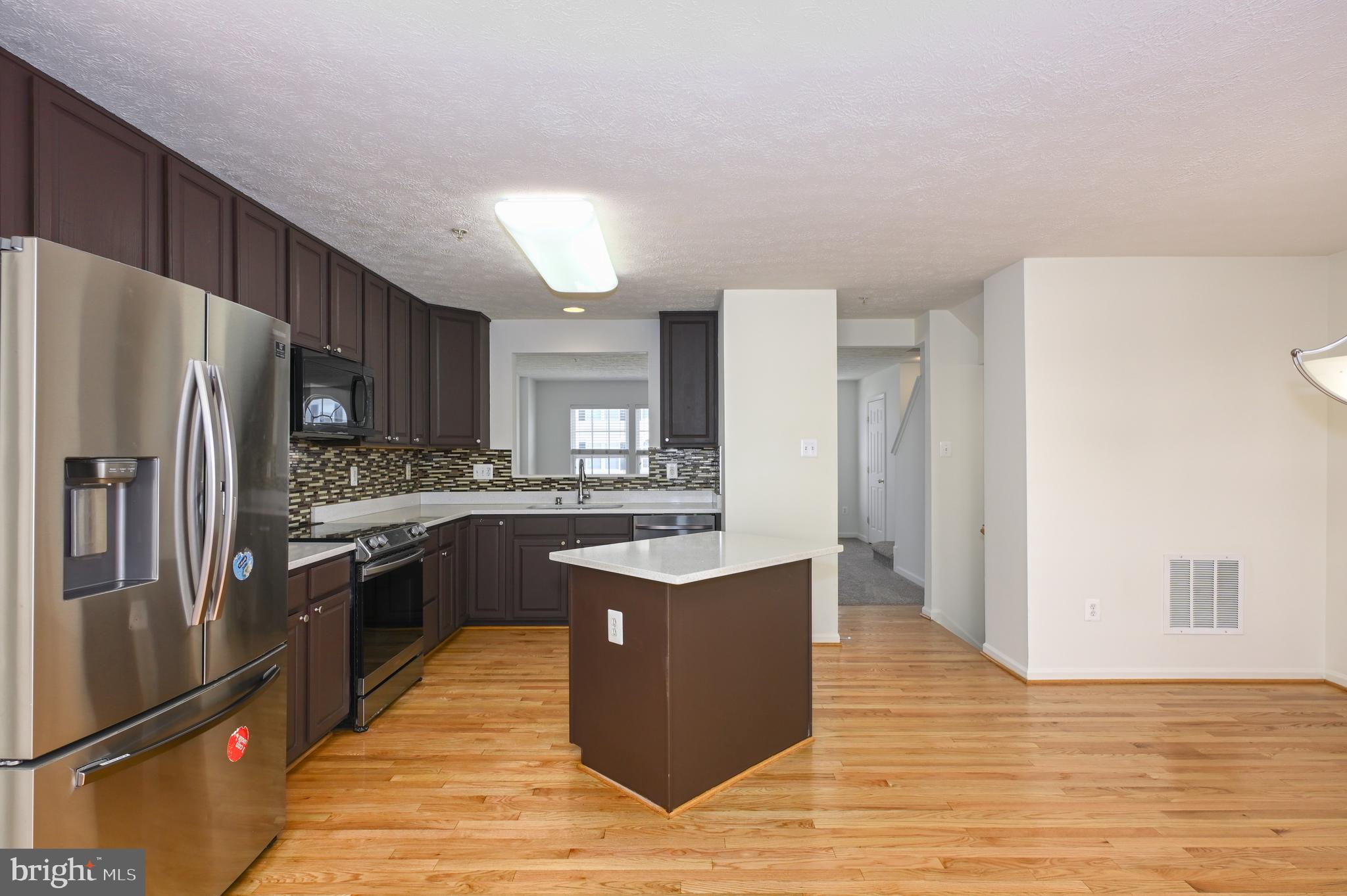 9871 Decatur Road Baltimore, MD 21220 - Photo 24 of 31 a kitchen with stainless steel appliances granite countertop a refrigerator and a stove