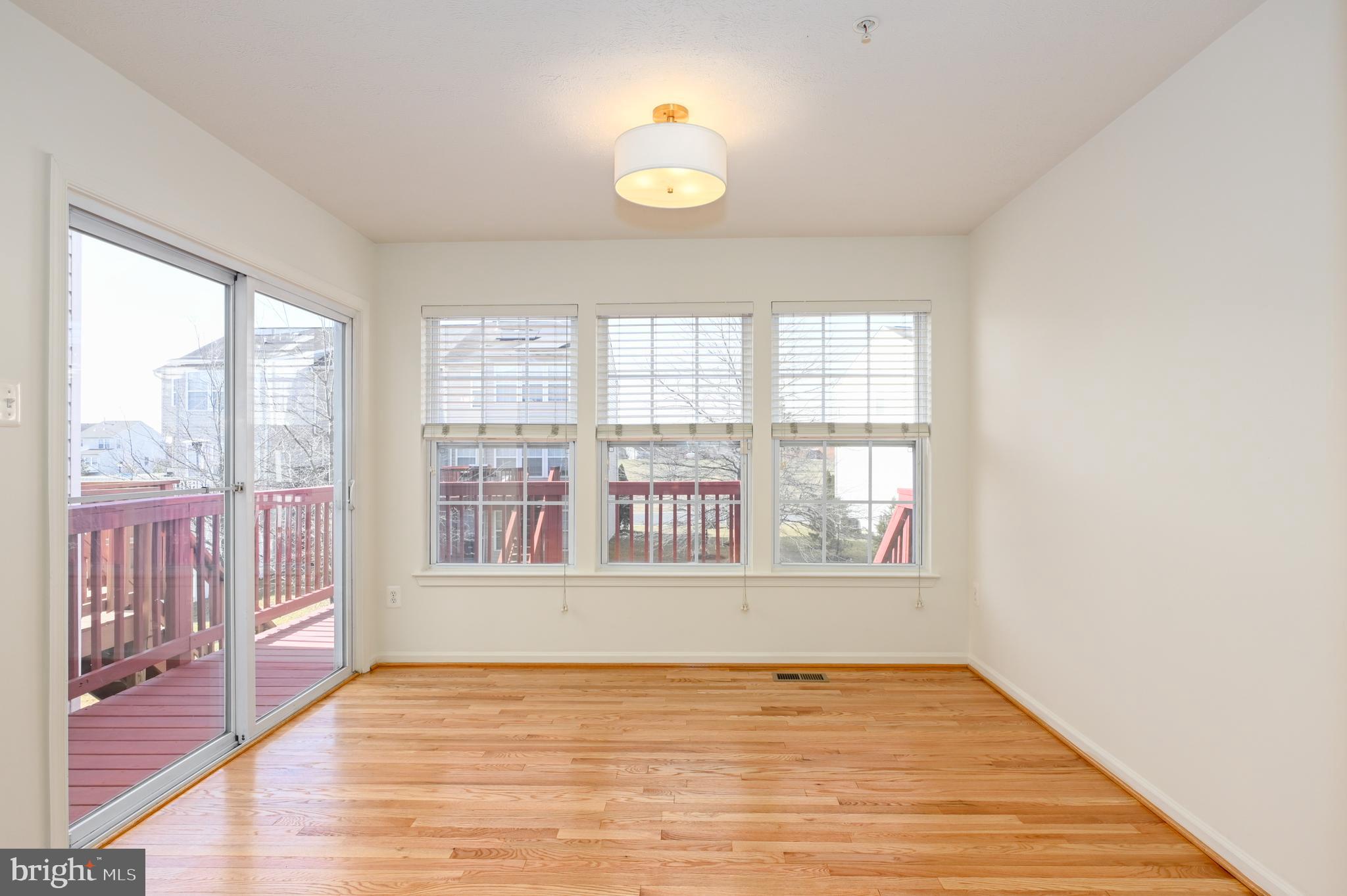 9871 Decatur Road Baltimore, MD 21220 - Photo 26 of 31 a view of an empty room with wooden floor and a window