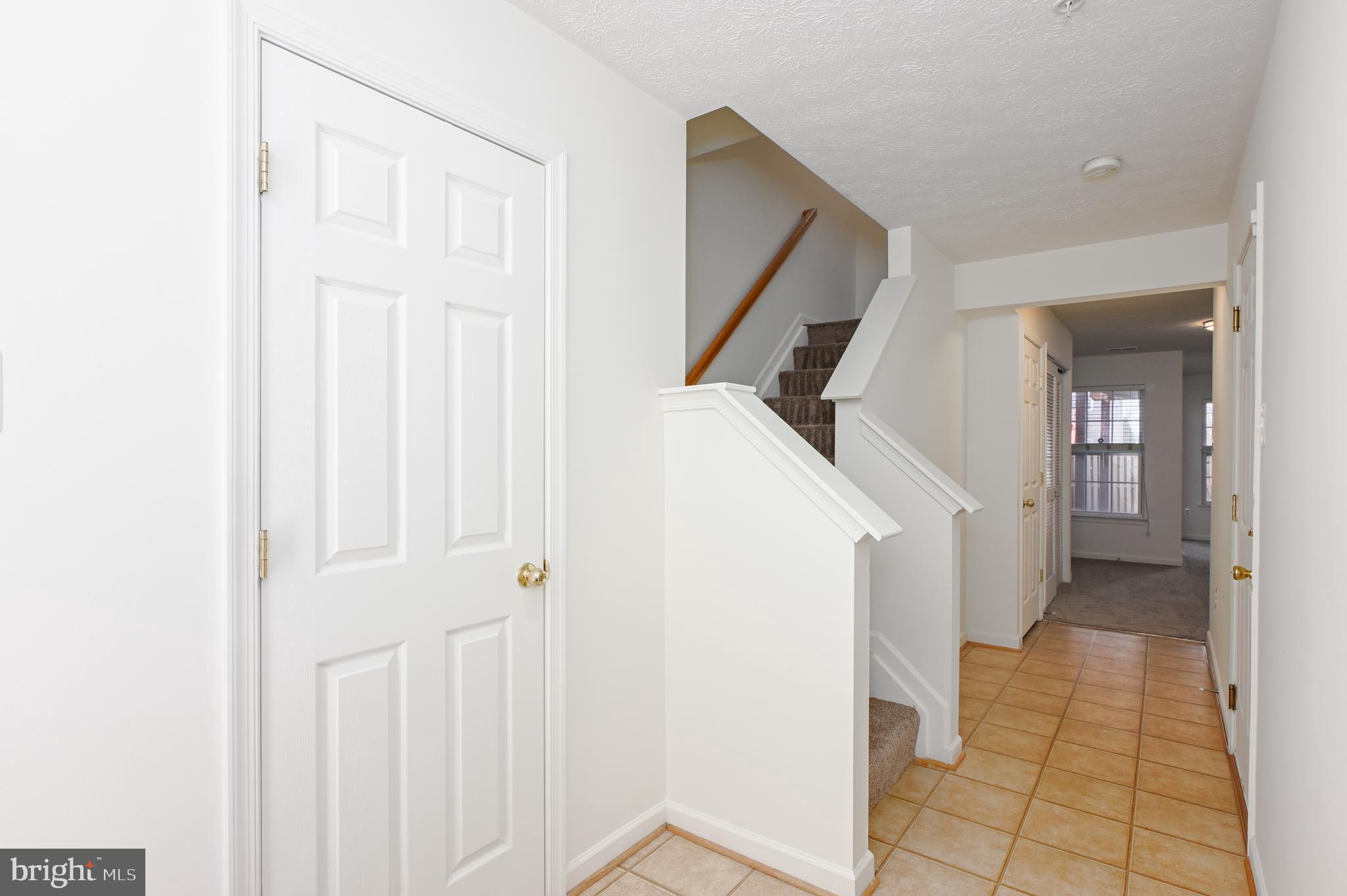9871 Decatur Road Baltimore, MD 21220 - Photo 4 of 31 a view of a hallway with wooden floor and entryway