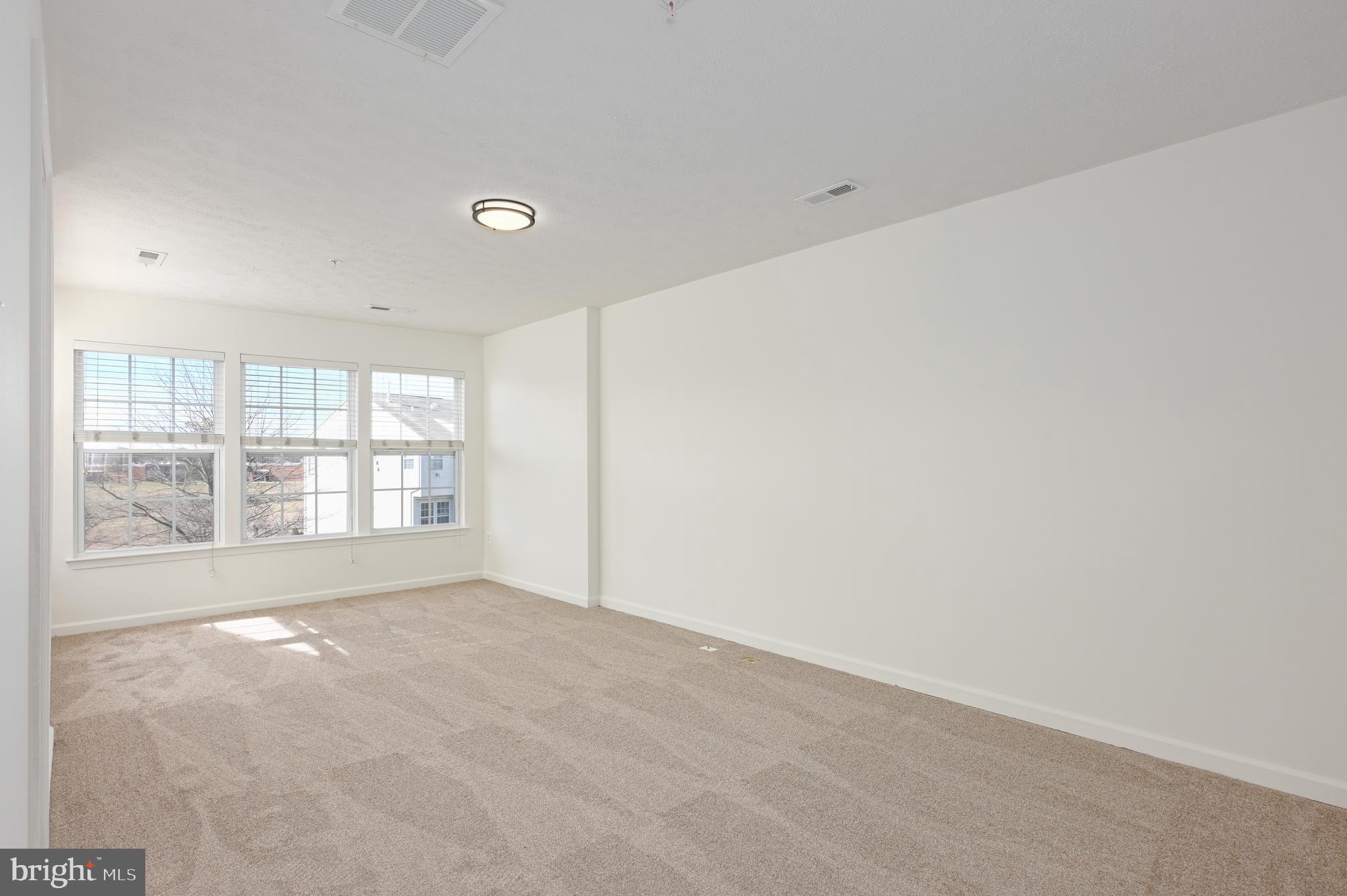 9871 Decatur Road Baltimore, MD 21220 - Photo 8 of 31 a view of an empty room with a window