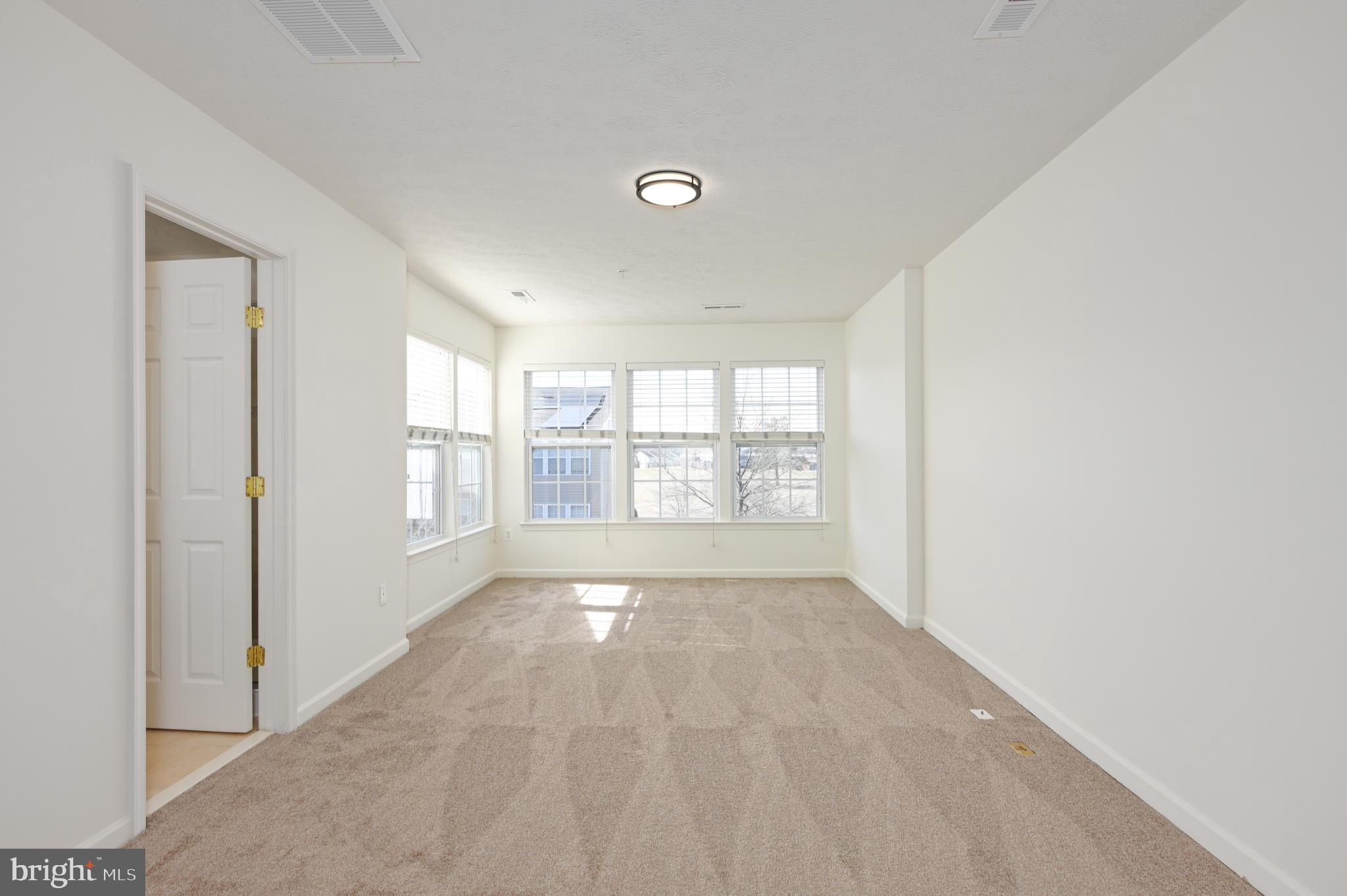 9871 Decatur Road Baltimore, MD 21220 - Photo 9 of 31 a view of an empty room with a window