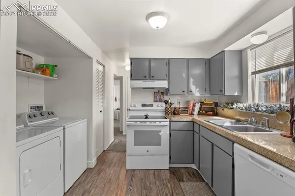 a kitchen with a sink a stove and cabinets