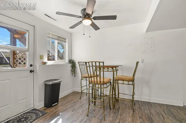 a view of a dining room with furniture and wooden floor