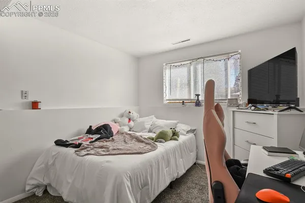 a bedroom with furniture and a flat screen tv