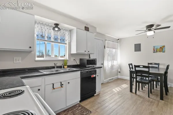 a kitchen with a table chairs stove and cabinets