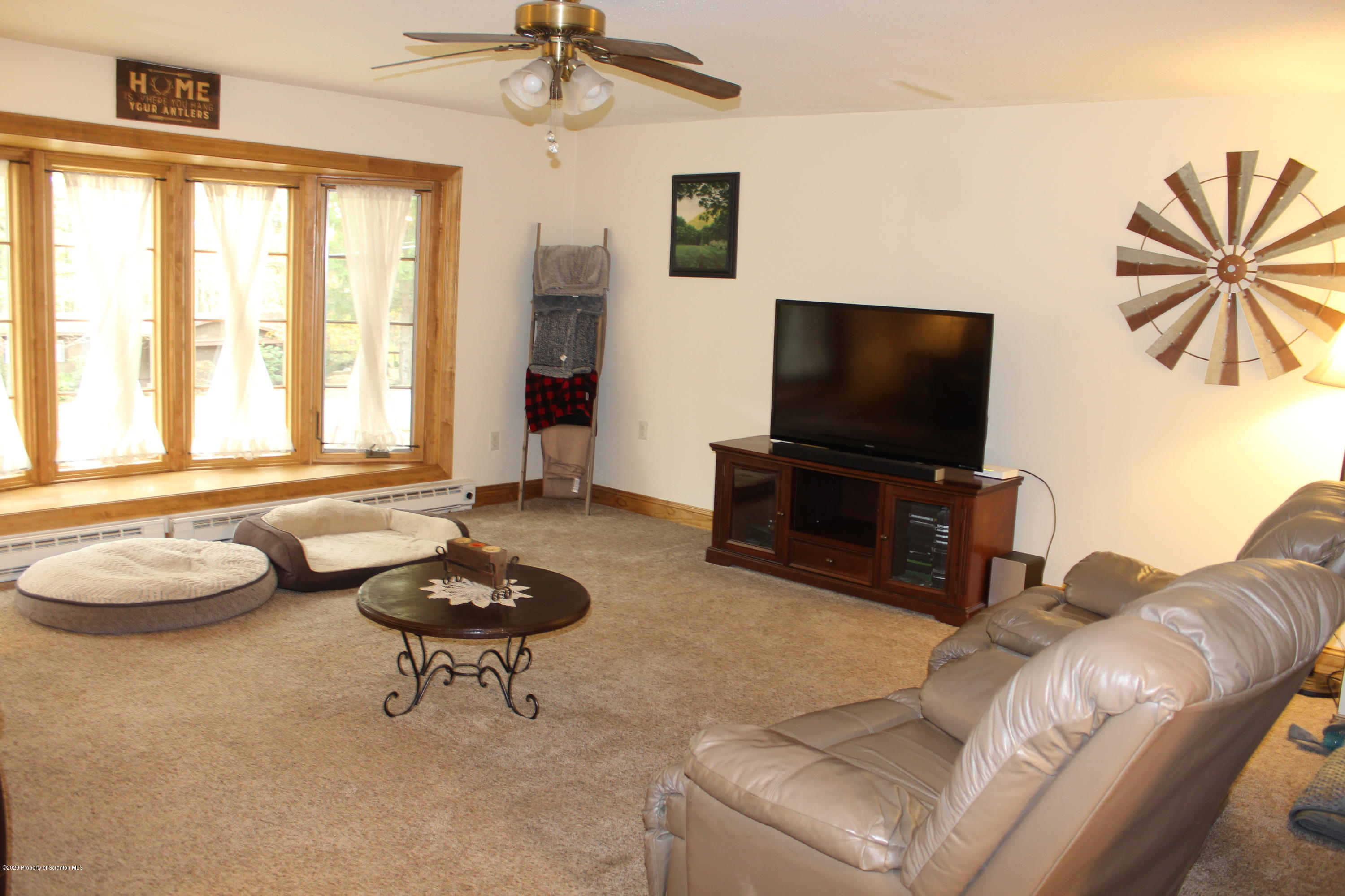 441 State Rte 1002 Tunkhannock, PA 18657 - Photo 6 of 52 a living room with furniture and a flat screen tv