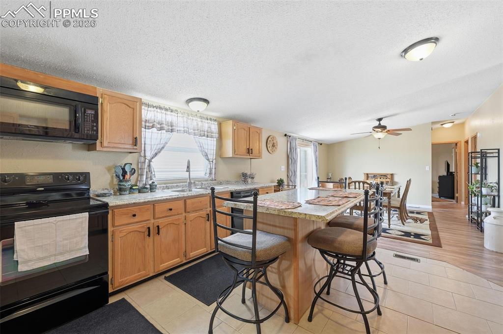 20985 McDaniels Road Calhan, CO 80808 - Photo 24 of 41 a kitchen with stainless steel appliances granite countertop a stove and cabinets