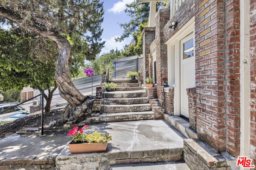 313 Museum Drive Los Angeles, CA 90065 - Photo 6 of 43 a front view of a house with a garden