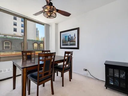 a view of a dining room with furniture and window