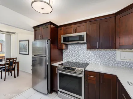 a kitchen with stainless steel appliances granite countertop a refrigerator stove and sink