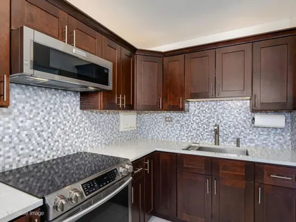 a kitchen with wooden cabinets and a stove top oven