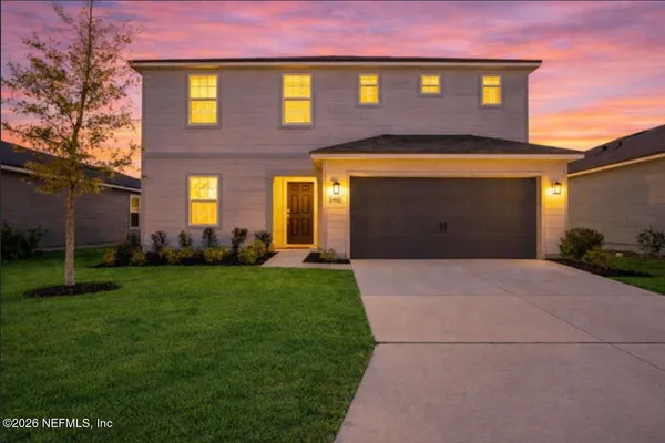 a front view of a house with a yard and garage