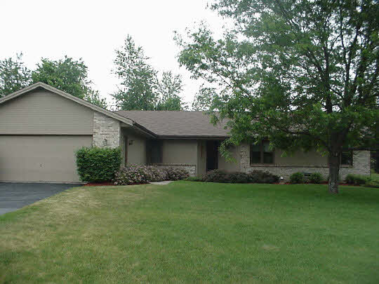 4428 Montclair Road Roscoe, IL 61073 - Photo 1 of 6 a view of a house with a yard and a large tree