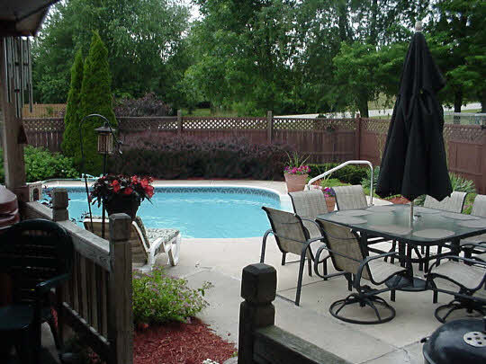 4428 Montclair Road Roscoe, IL 61073 - Photo 2 of 6 a view of a backyard with furniture and a garden