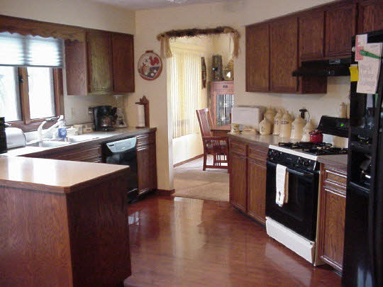 4428 Montclair Road Roscoe, IL 61073 - Photo 3 of 6 a kitchen with stainless steel appliances granite countertop a stove top oven a sink and dishwasher a oven with wooden floors