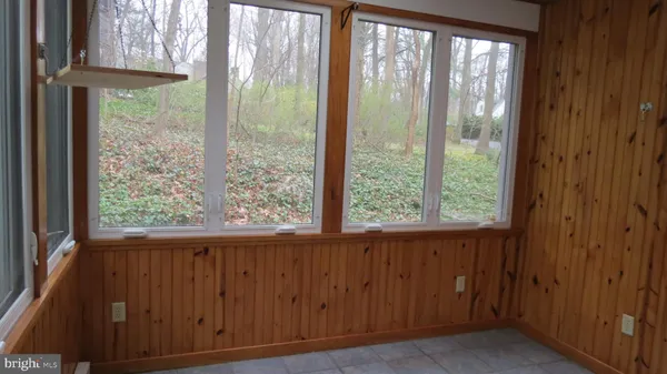 a room with wooden floor and white walls