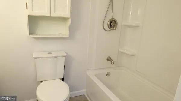 a bathroom with a toilet and a bathtub