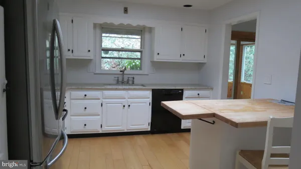 a kitchen with a stove a sink and a refrigerator
