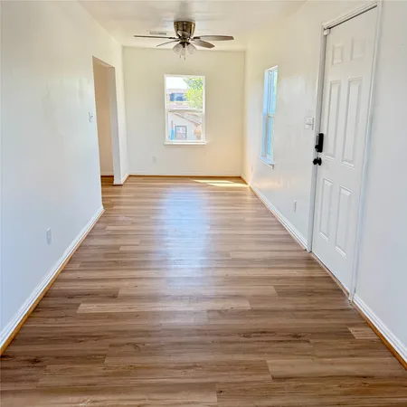 wooden floor in an empty room with a window