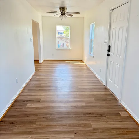 wooden floor in an empty room with a window