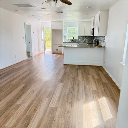 a view of a kitchen with a sink and cabinets