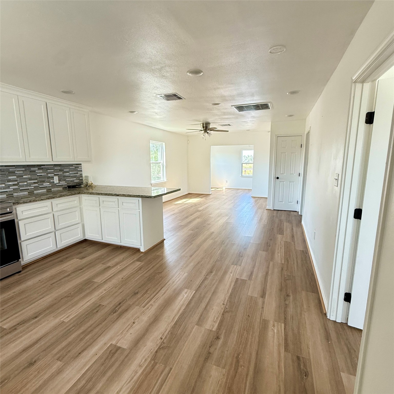 143 Bastrop Bayou Drive Angleton, TX 77515 - Photo 18 of 32 a view of a kitchen with wooden floor and electronic appliances