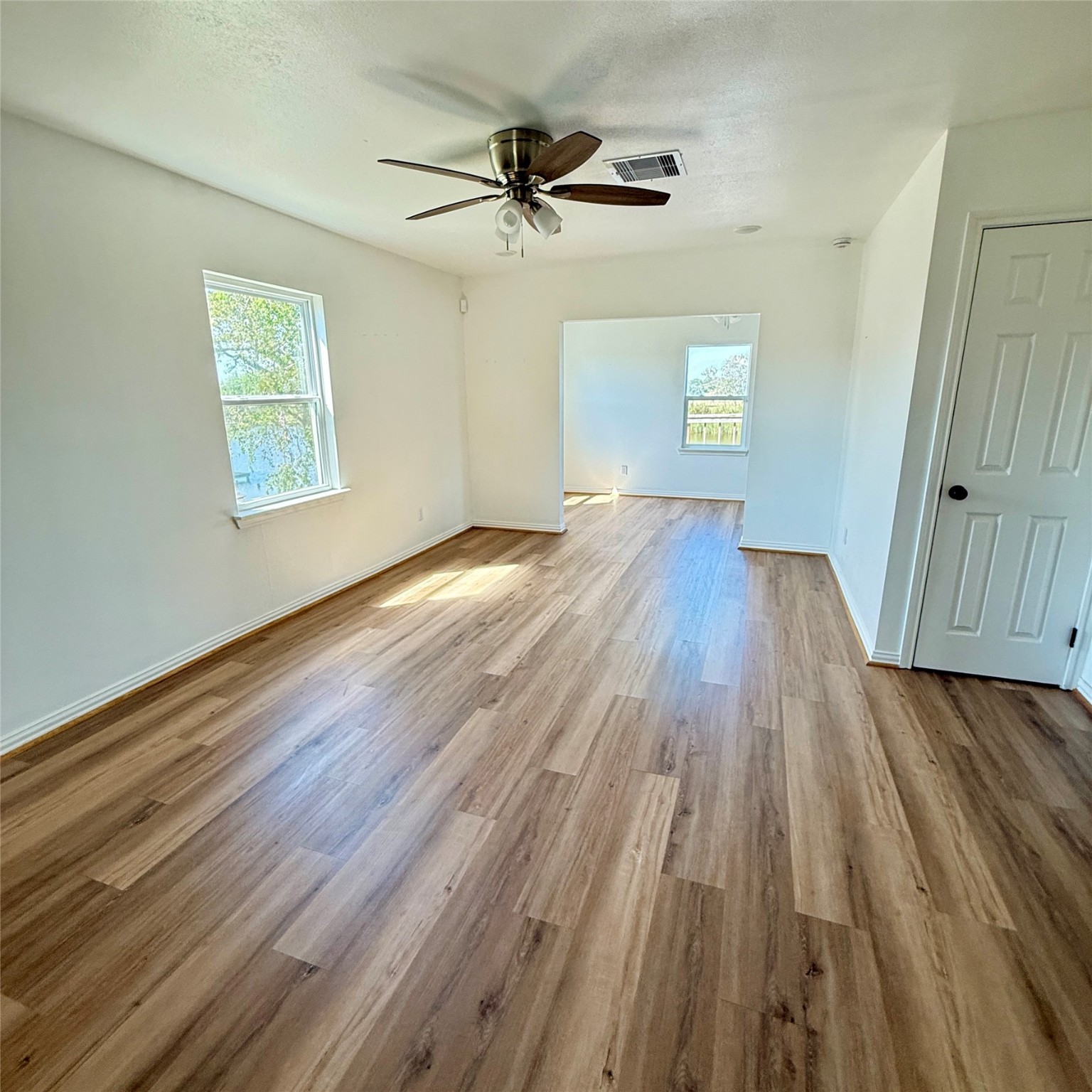 143 Bastrop Bayou Drive Angleton, TX 77515 - Photo 21 of 32 wooden floor in an empty room with a window
