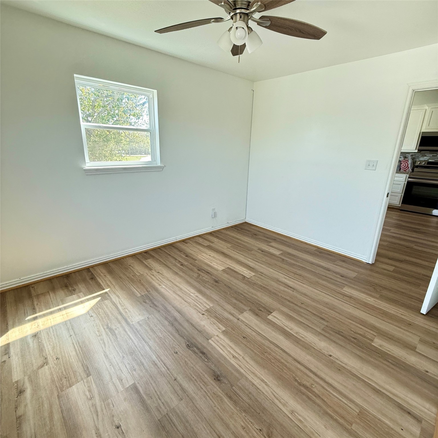 143 Bastrop Bayou Drive Angleton, TX 77515 - Photo 27 of 32 wooden floor in an empty room with a window