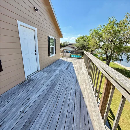 a view of balcony with wooden floor and fence