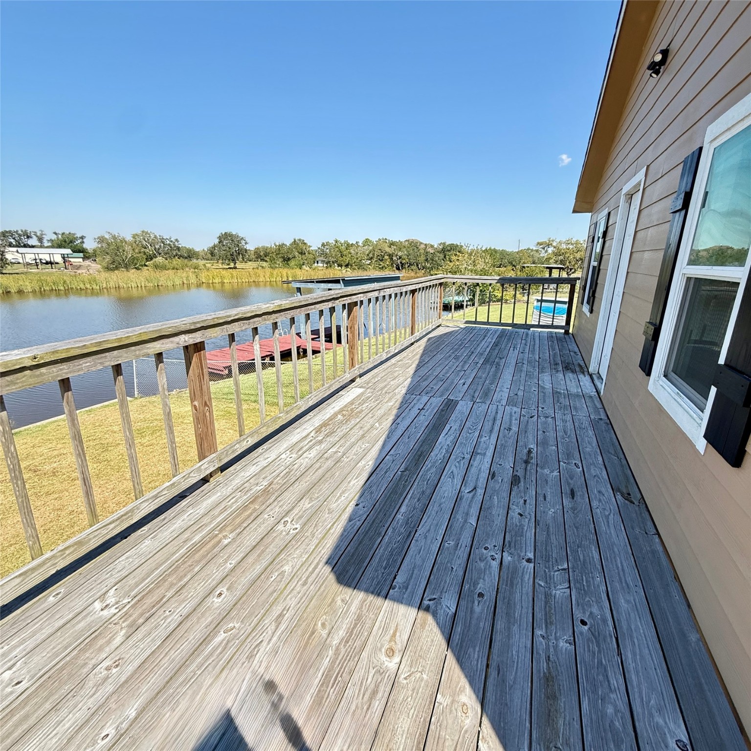 143 Bastrop Bayou Drive Angleton, TX 77515 - Photo 32 of 32 a view of wooden balcony with wooden floor and city view