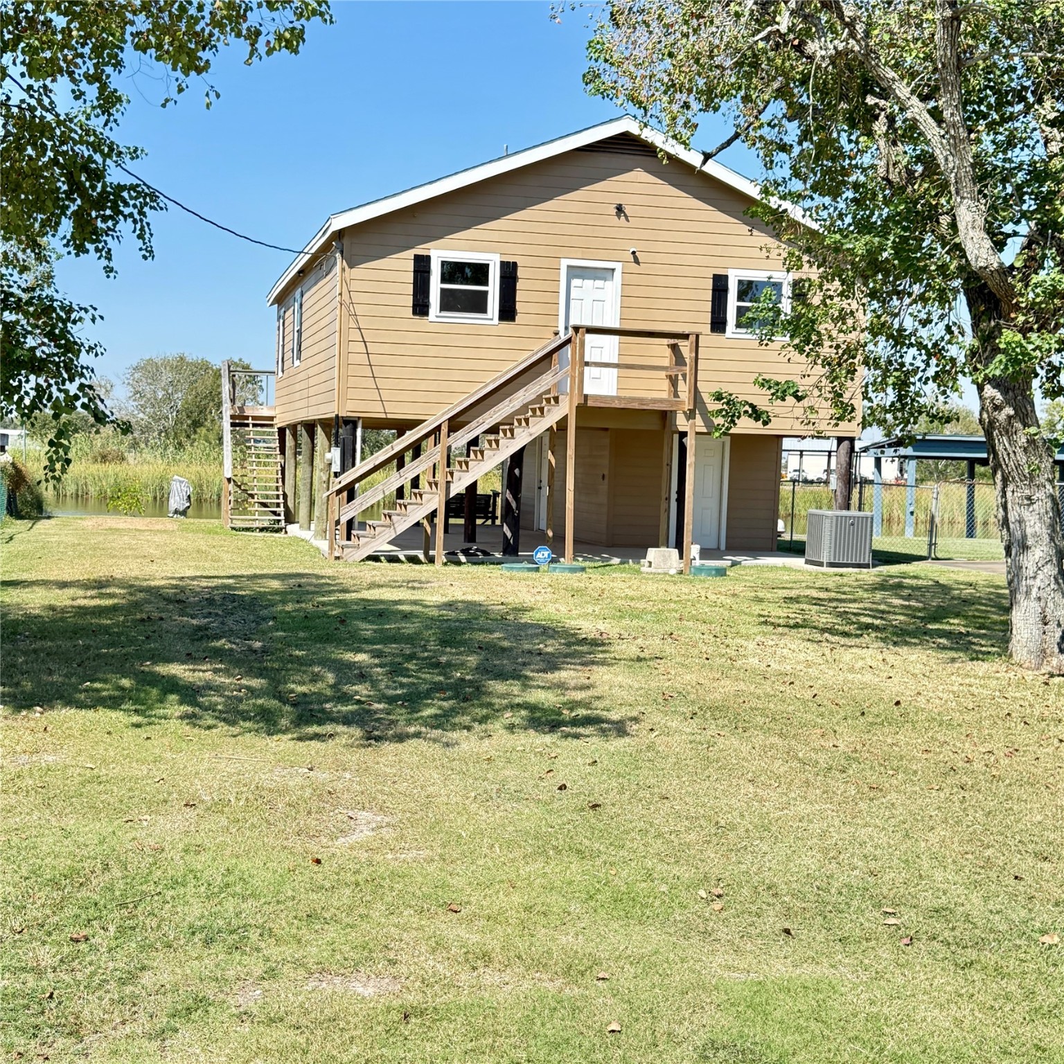 143 Bastrop Bayou Drive Angleton, TX 77515 - Photo 4 of 32 a view of a white house with a yard