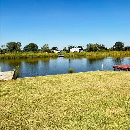 a view of a ocean with boats and trees in the background