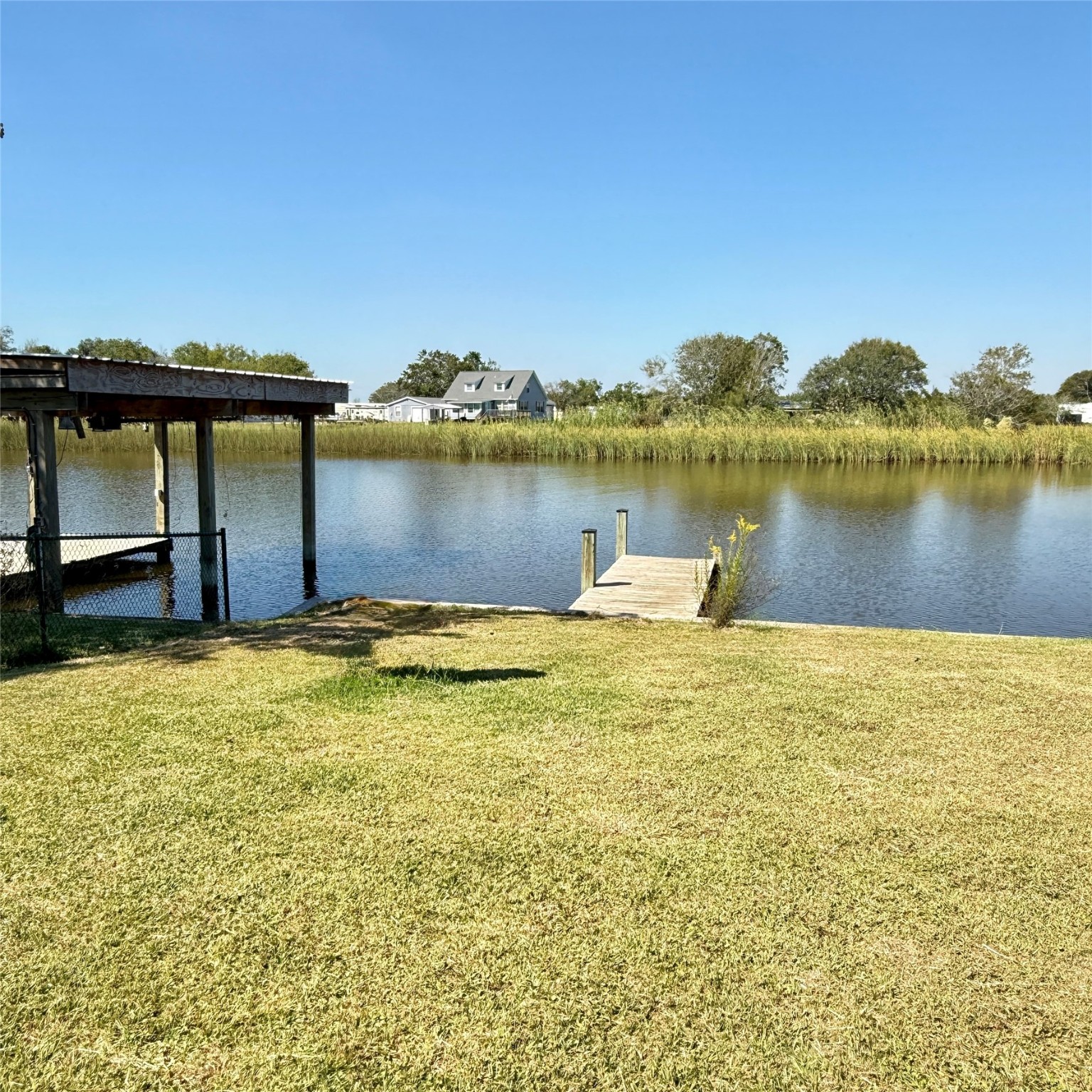 143 Bastrop Bayou Drive Angleton, TX 77515 - Photo 8 of 32 a view of a lake with a big yard