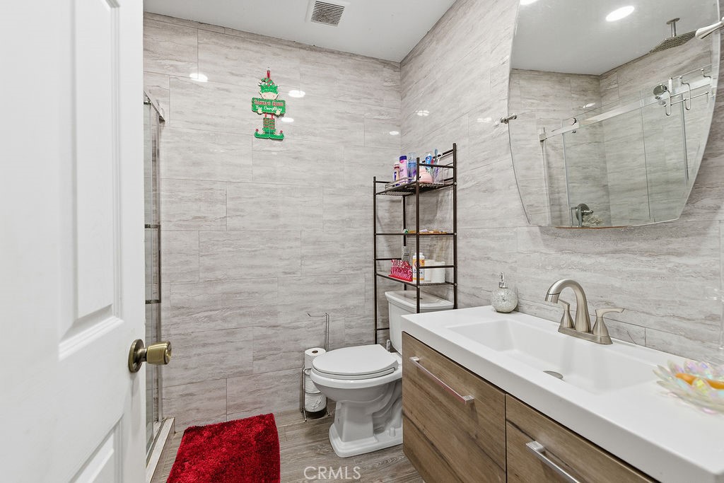 5390 Karling Place Palmdale, CA 93552 - Photo 14 of 36 a bathroom with a toilet sink and mirror