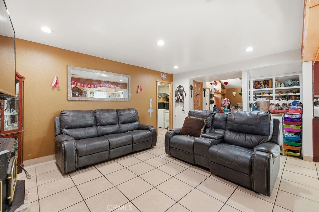 5390 Karling Place Palmdale, CA 93552 - Photo 24 of 36 a living room with furniture and a flat screen tv