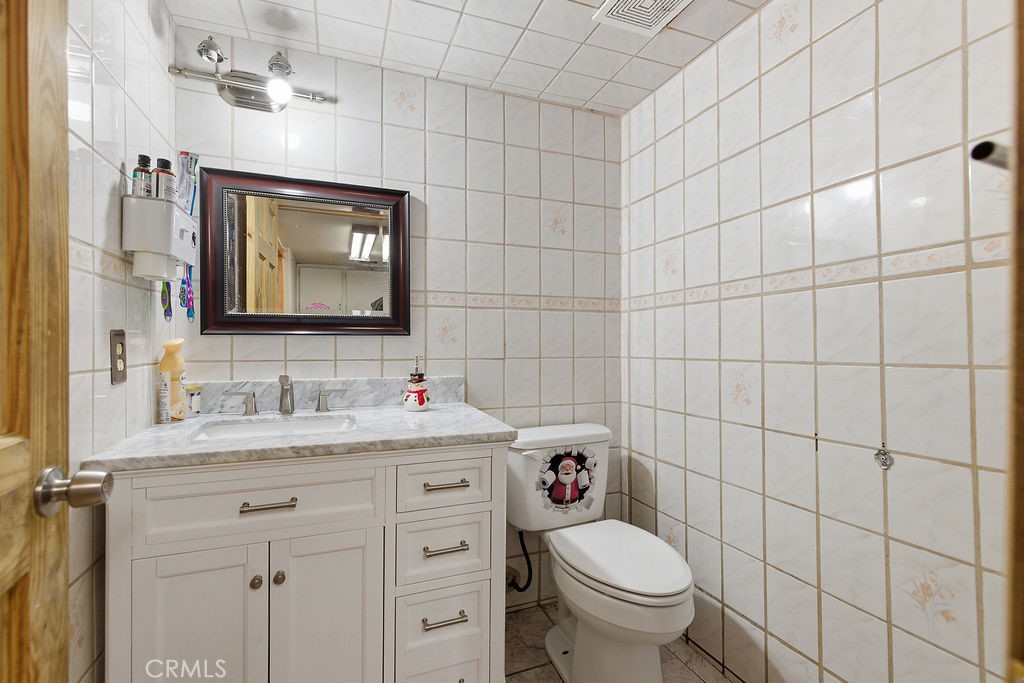 5390 Karling Place Palmdale, CA 93552 - Photo 26 of 36 a bathroom with a granite countertop toilet sink and mirror