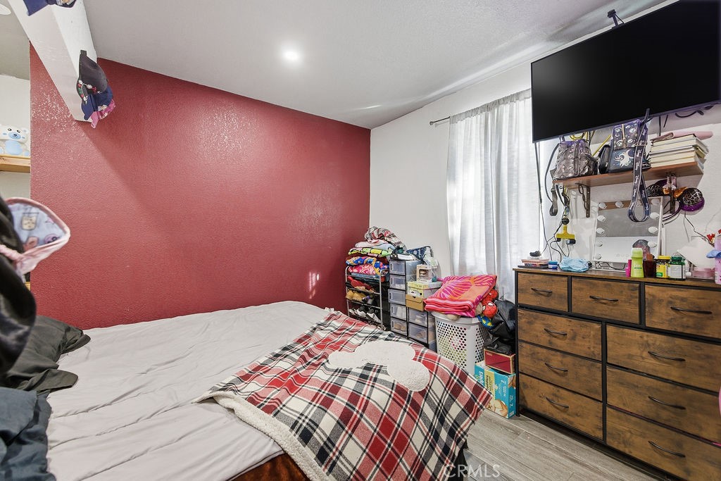 5390 Karling Place Palmdale, CA 93552 - Photo 27 of 36 a bedroom with a bed and a flat screen tv