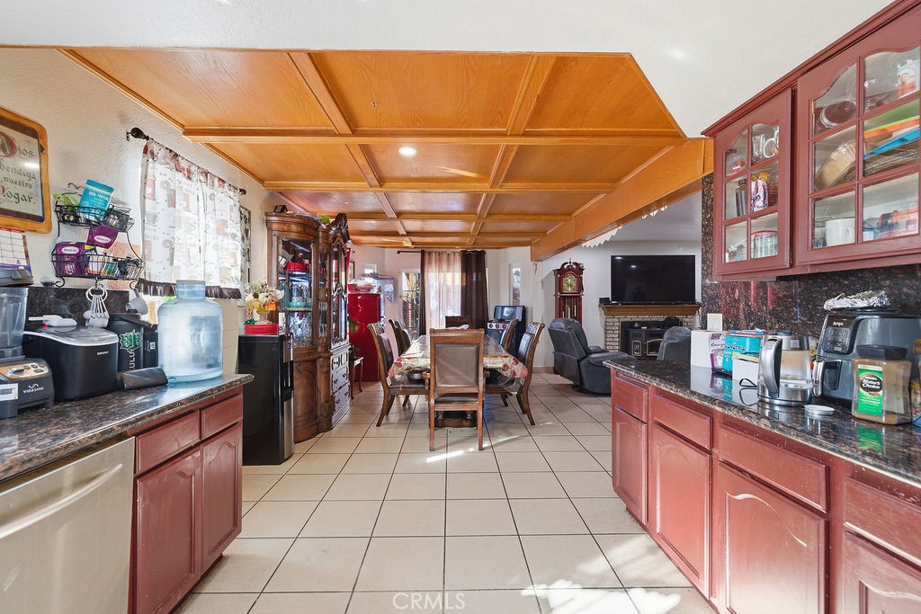 5390 Karling Place Palmdale, CA 93552 - Photo 29 of 36 a kitchen with stainless steel appliances kitchen island granite countertop a sink and cabinets