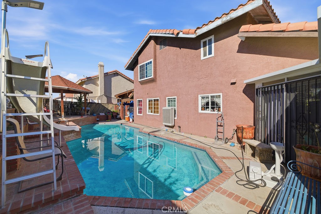5390 Karling Place Palmdale, CA 93552 - Photo 33 of 36 a view of a house with backyard water and sitting area