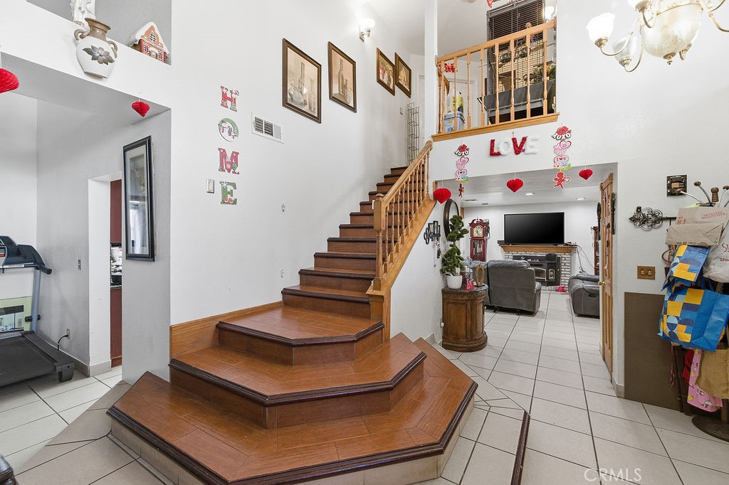 5390 Karling Place Palmdale, CA 93552 - Photo 6 of 36 a room with lots of white furniture and paintings on the wall