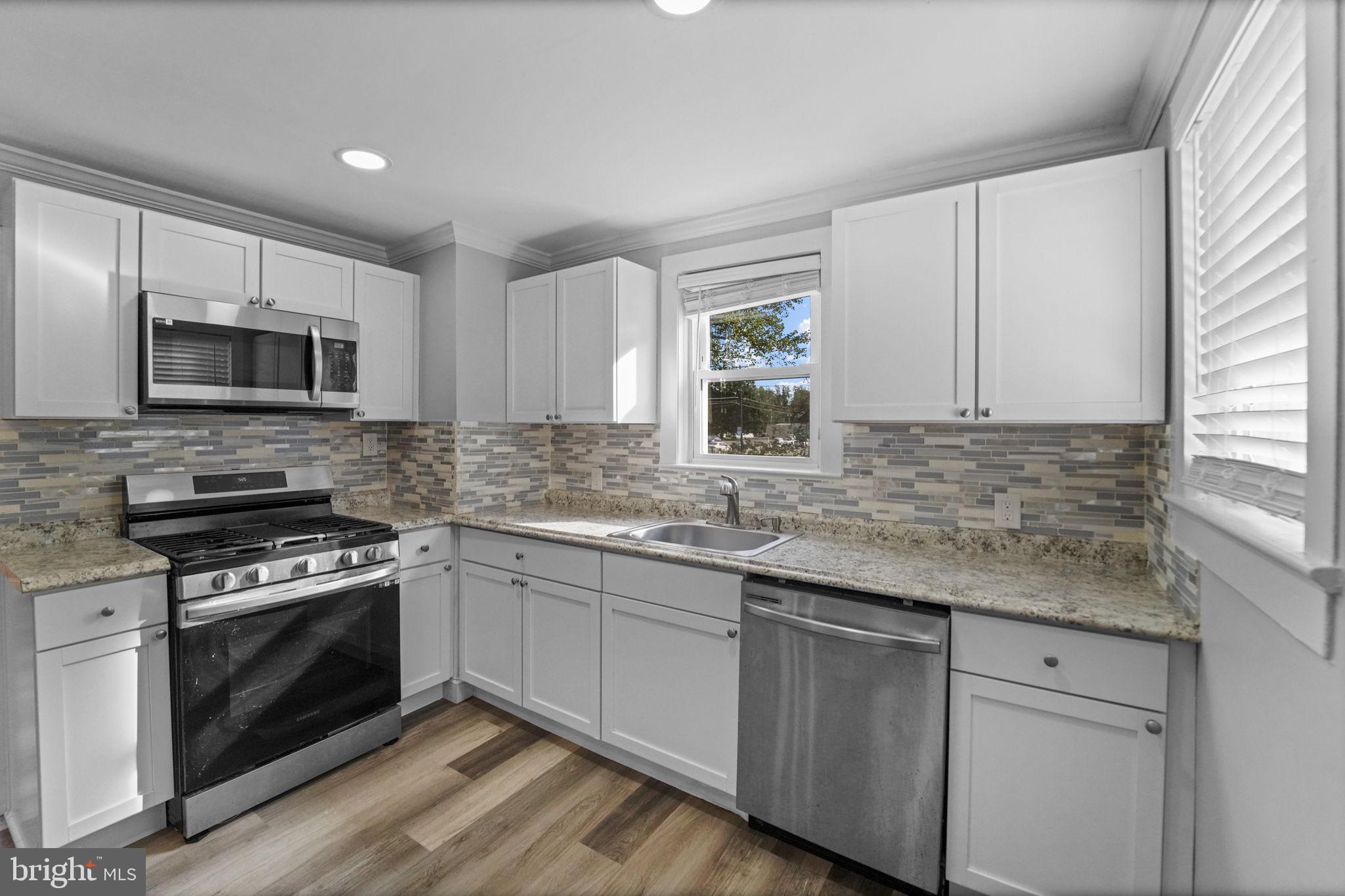 2652 South Main Road Vineland, NJ 08360 - Photo 20 of 44 a kitchen with sink a microwave a stove and cabinets