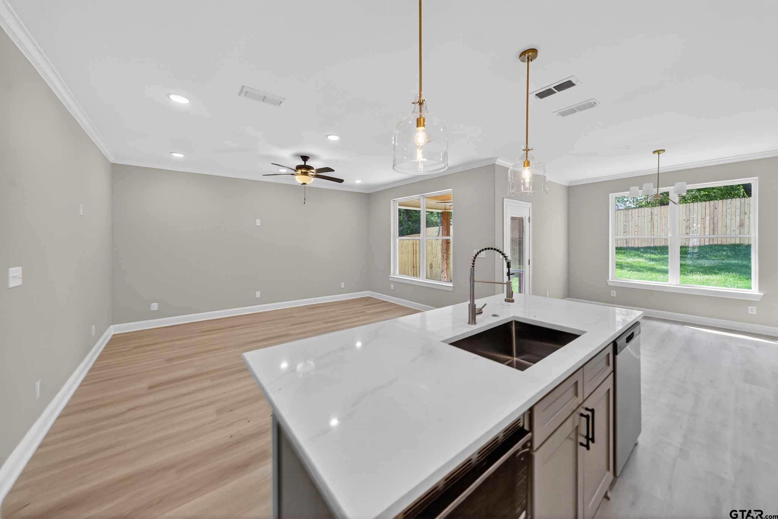 3049 Guinn Farms Road Tyler, TX 75707 - Photo 12 of 43 a kitchen that has a sink and a stove with wooden floor