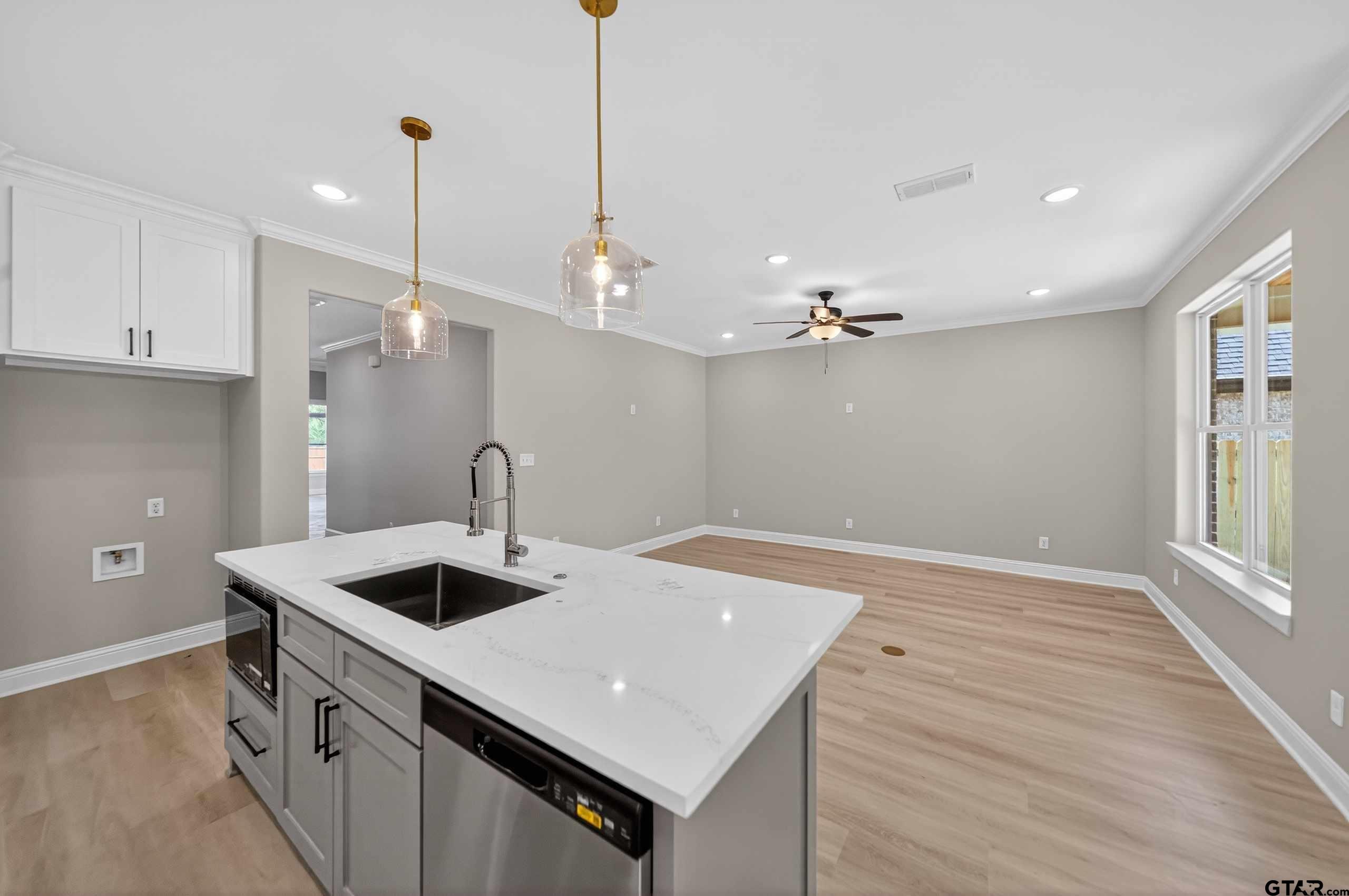 3049 Guinn Farms Road Tyler, TX 75707 - Photo 14 of 43 a kitchen with a sink a stove and a refrigerator