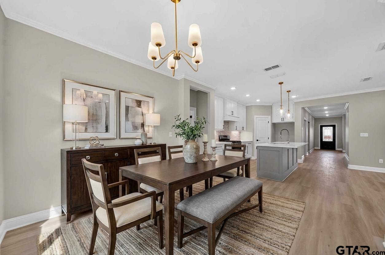 3049 Guinn Farms Road Tyler, TX 75707 - Photo 16 of 43 a view of a dining room with furniture and wooden floor